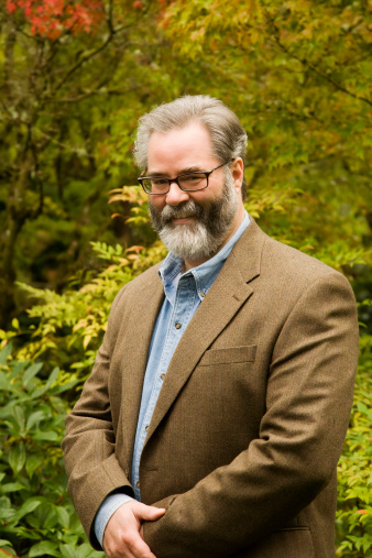 Portrait of a mature professor with 'salt & pepper' hair and beard.