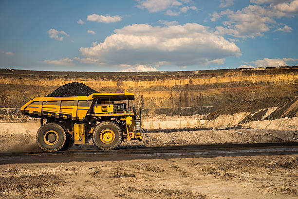 Dump Truck with Coal on a Haul Road Dump Truck on Haul Road dump truck photos stock pictures, royalty-free photos & images