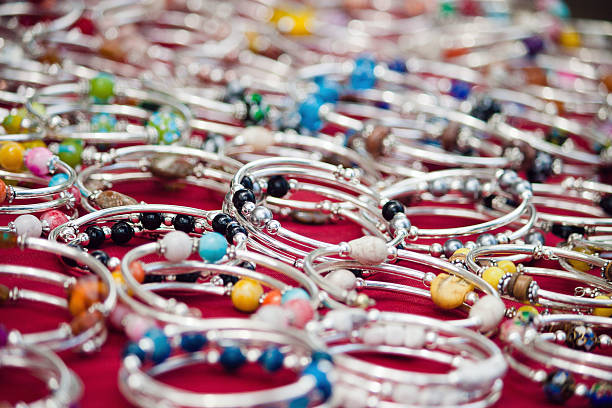 A detailed close-up of colorful handmade beaded bracelets displayed together, featuring vibrant designs, patterns, and letter beads spelling “BFF.” The image emphasizes creativity, fashion, and artistic craftsmanship, showcasing jewelry-making as a fun and expressive activity.