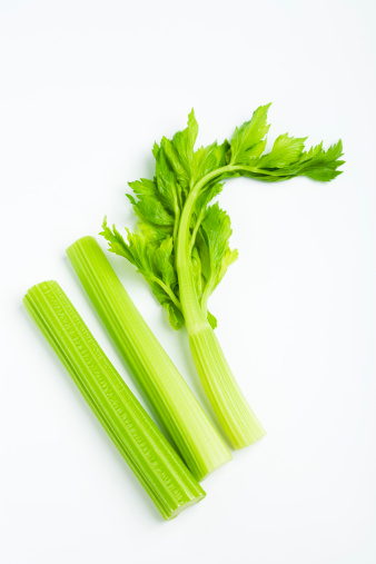 celery stalk with leaves on white