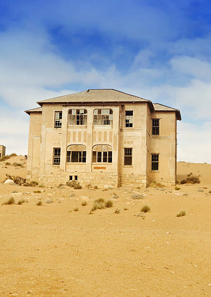 Abandoned house Abandoned building in Kolmanskop,a ghost town in the restricted diamond mining area,Luderitz,Namibia. kolmanskop namibia stock pictures, royalty-free photos & images