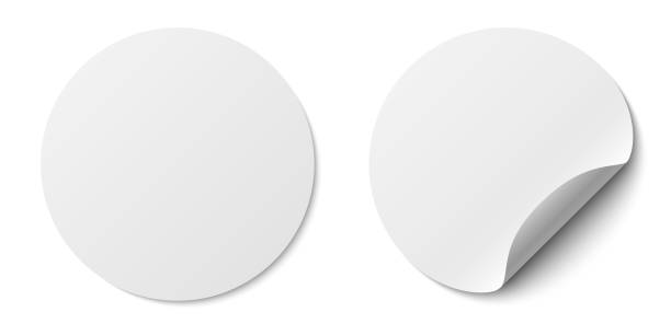 istock Circle adhesive symbols. White tags, paper round stickers with peeling corner and shadow, isolated rounded plastic mockup, realistic two round paper adhesive sticker mockup with curved corner 1724323124