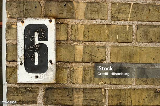 Black Number 6 Posted On White On A Rough Brick Wall Stock Photo - Download Image Now