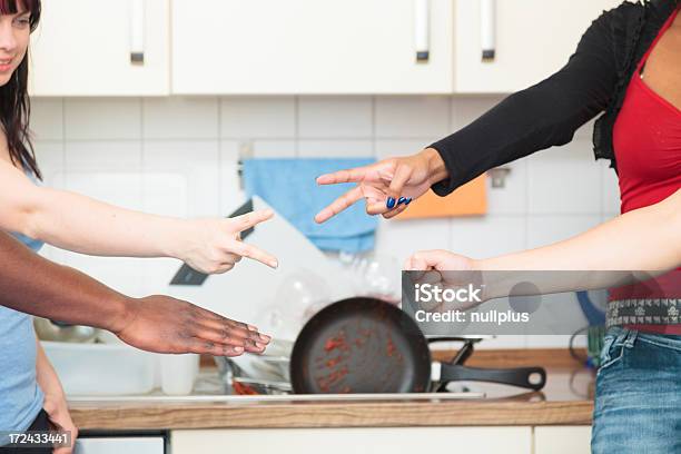 Friends Arguing Over Who Has To Do The Dishes Stock Photo - Download Image Now - Cooking, Crockery, Housework