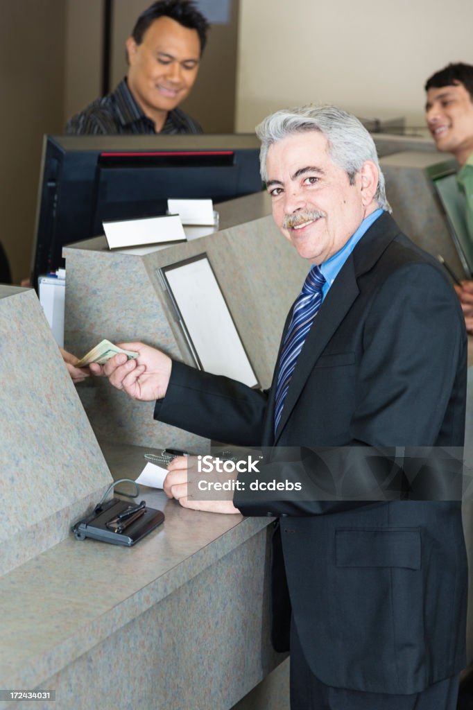 Bank Customer A bank teller assists a customer. Bank - Financial Building Stock Photo