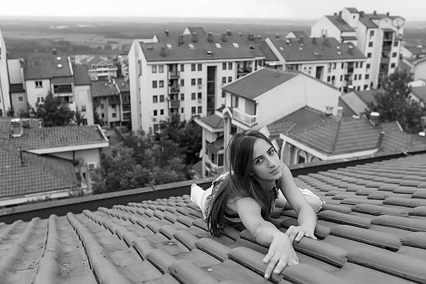 beauty in torn jeans posing on the roof