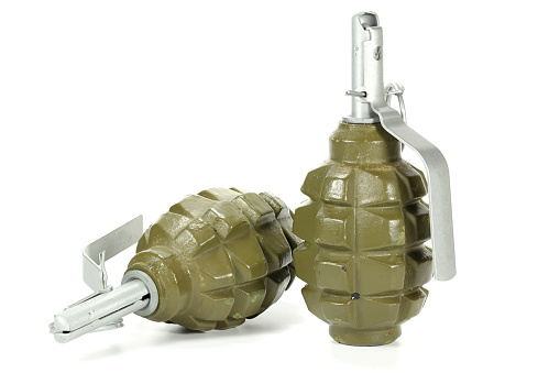 Top of a military hand grenade with pin intact.  White background   MORE LIKE THIS... in lightboxes below.