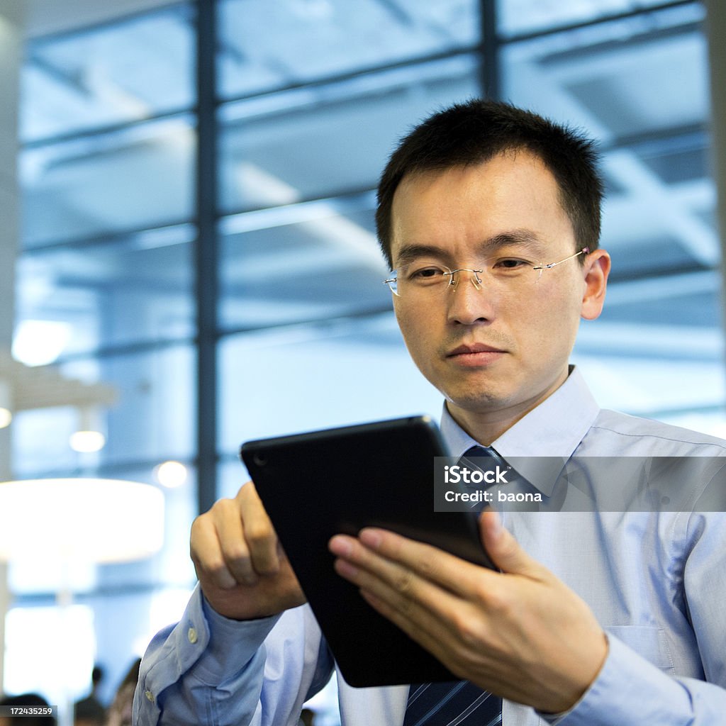 working with tablet PC Young businessman working with tablet PC in an office building. 30-34 Years Stock Photo