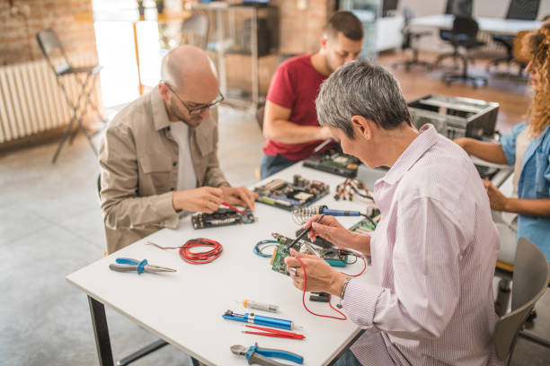istock A group of students repairing a broken computer motherboard. Hardware support. Electronic technology, use of multimeter 1724353826