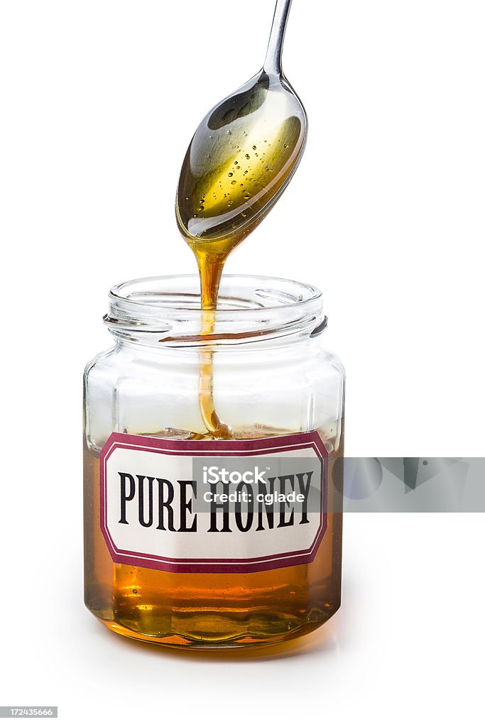 Reinem Honig Tropfen von Spoon - Lizenzfrei Einmachglas Stock-Foto