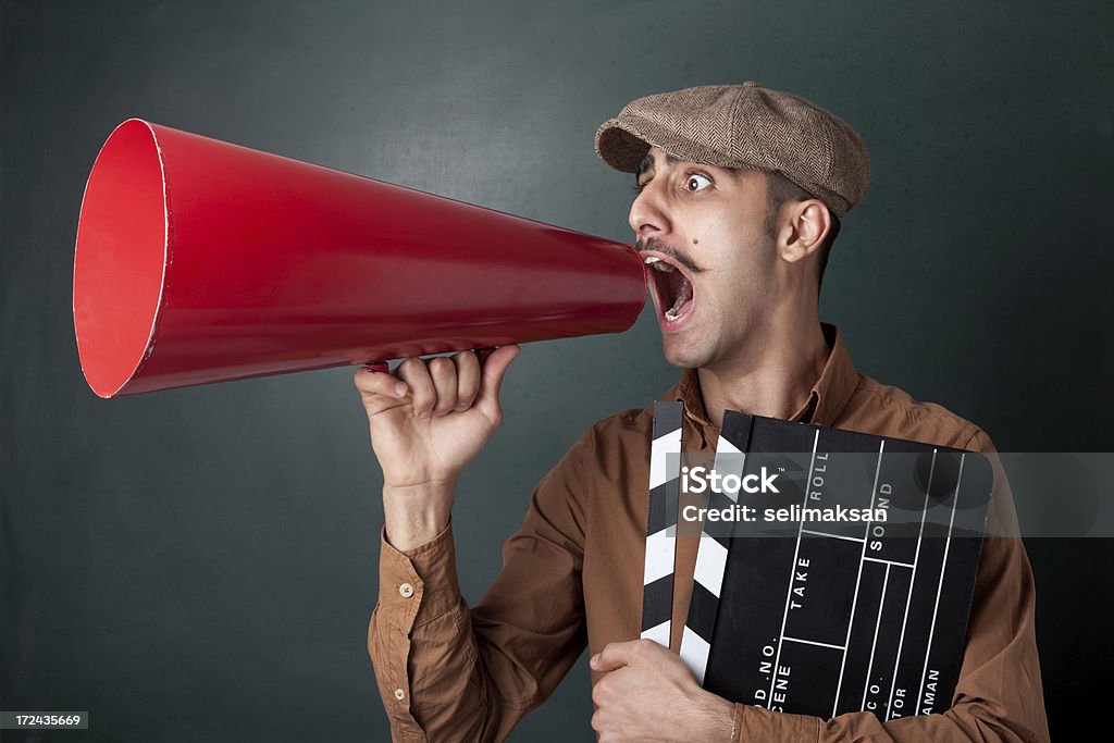 Man Shouting With Megaphone Man shouting on megaphone Film Director Stock Photo