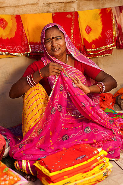 istock Woman selling colorful fabrics 172435865