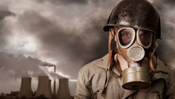 istock Man with gas mask in polluted industrial landscape 172436242