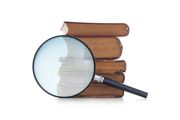 istock Magnifying glass and old books 172436371