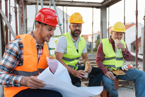 istock During an lunch break on a construction site, Caucasian architect, building contractor and engineer, looking at blueprint 1724363895