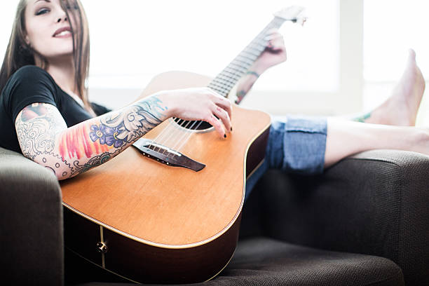 istock Guitar Playing Young woman 172436570