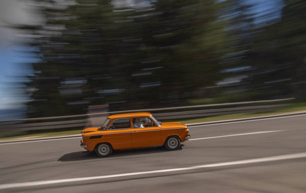 Rossfeld Panoramastrasse, Berchtesgaden, Germany - September 4, 2023: Vintage car riving up a mountain road. Panning shot with out of focus areas