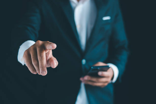 istock Close-up of a businessman using a smartphone Point and open your hand 1724368177
