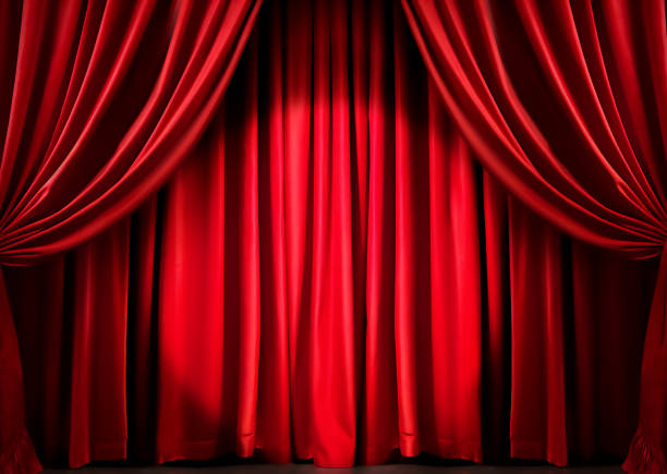 istock Theater stage with closed red curtain with spotlight 1724370305