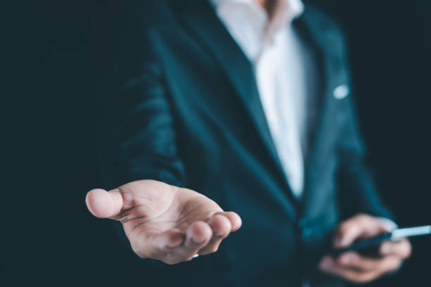 istock Close-up of a businessman using a smartphone Point and open your hand 1724371886