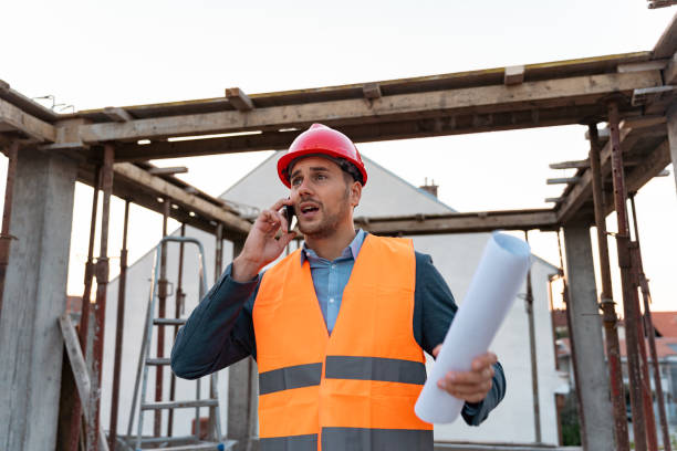 istock Worried young male Caucasian architect, talking on a mobile phone, on a construction site 1724371890