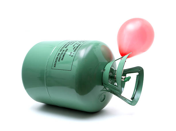 Helium gas cylinder and balloon isolated on white background Helium gas cylinder and balloon isolated on white background. helium stock pictures, royalty-free photos & images
