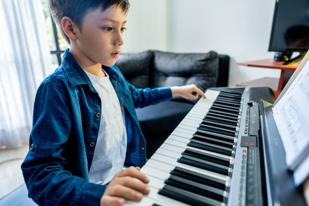 istock Boy playing synthesizer at home 1724380017