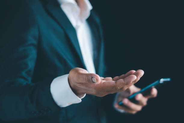 istock Close-up of a businessman using a smartphone Point and open your hand 1724380252