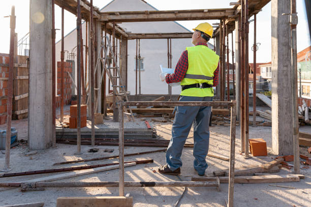 istock Unrecognizable senior Caucasian male building constructor doing the quality control on a construction site 1724380979