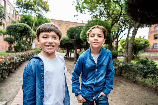 Portrait of twin brothers outdoors