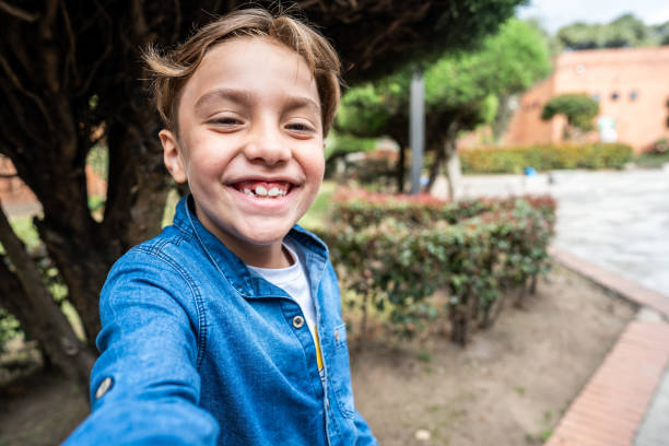 istock Boy taking a selfie outdoors - camera point of view 1724381152