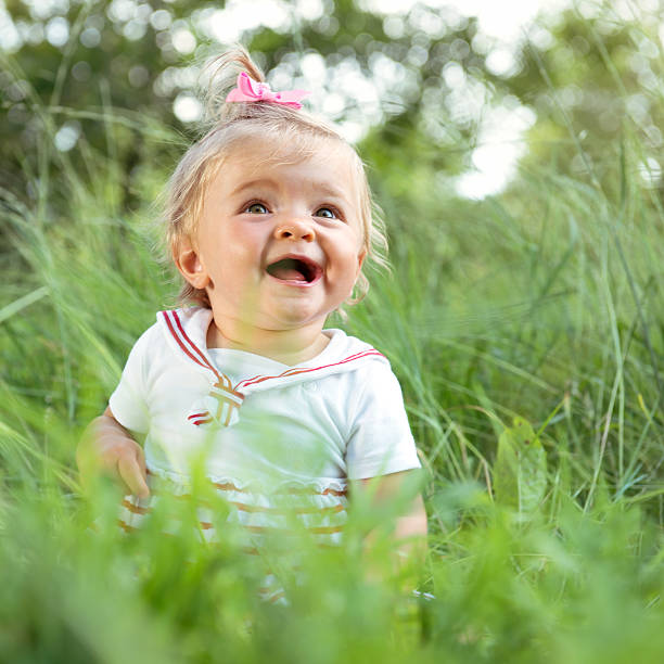 istock Cheerful baby sitting at park 172438134