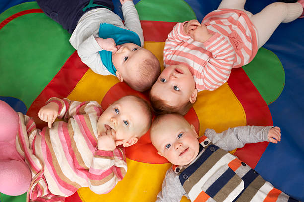 istock Overhead View Of Babies Lying On Mat At Playgroup 172438385