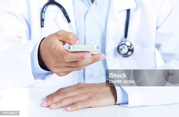 Doctor Using Smartphone Stock Photo - Download Image Now - Adult, Adults Only, Casual Clothing