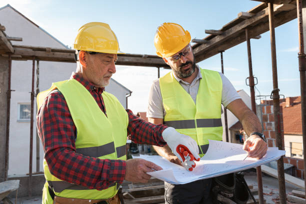 istock Caucasian engineer and building contractor having an meeting about project on a construction site 1724386041