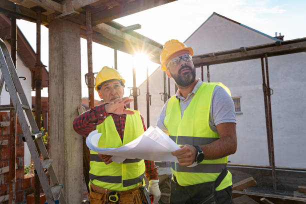 istock Caucasian engineer and building contractor having an meeting about project on a construction site 1724386043