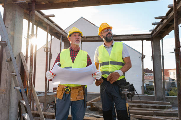 istock Caucasian architect and building contractor having an meeting about project on a construction site 1724386044