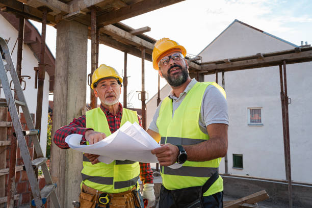 istock Caucasian architect and building contractor having an meeting about project on a construction site 1724386045
