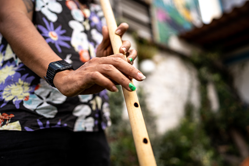 Close-up of a man playing bamboo flute