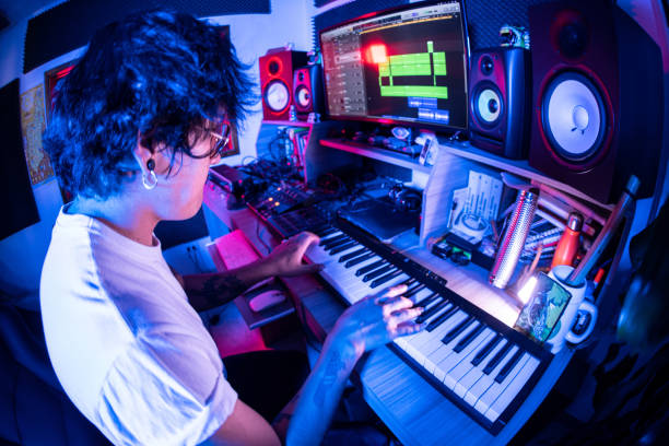 istock Man playing keyboard to do a music or remix at music studio 1724389804