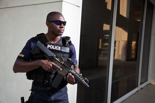 istock Police officer holding rifle 172439108