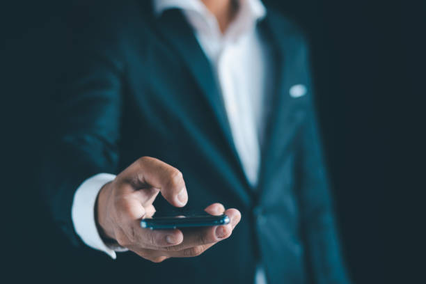 istock Close-up of a businessman using a smartphone Point and open your hand 1724394230