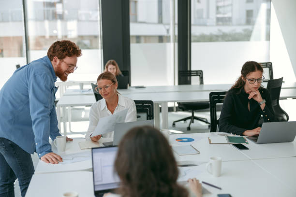 istock Business colleagues working together on project while sitting in office on colleagues background 1724394233