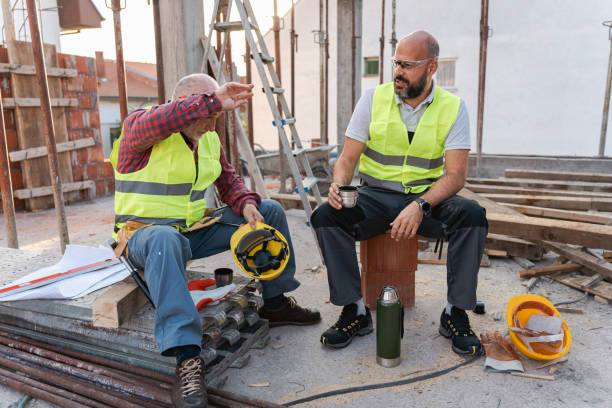 istock Tired male Caucasian construction workers, having an break on a construction site 1724394796