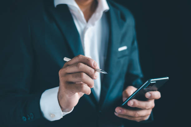 istock Close-up of a businessman using a smartphone Point and open your hand 1724395724