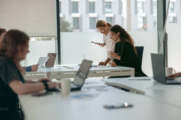 istock Business people working with laptops in office on colleagues background. Teamwork concept 1724398014