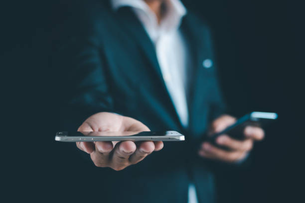 istock Close-up of a businessman using a smartphone Point and open your hand 1724399612
