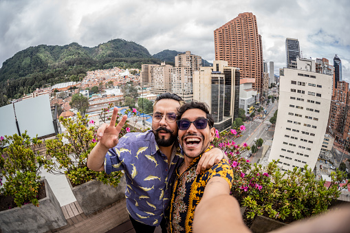 Gay couple taking a selfie at balcony - point of view