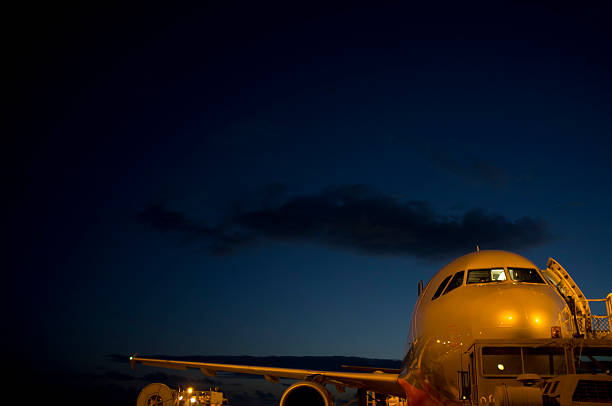 Aircraft being refuelled at Sydney airport at sunset