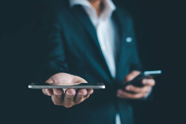 istock Close-up of a businessman using a smartphone Point and open your hand 1724401314